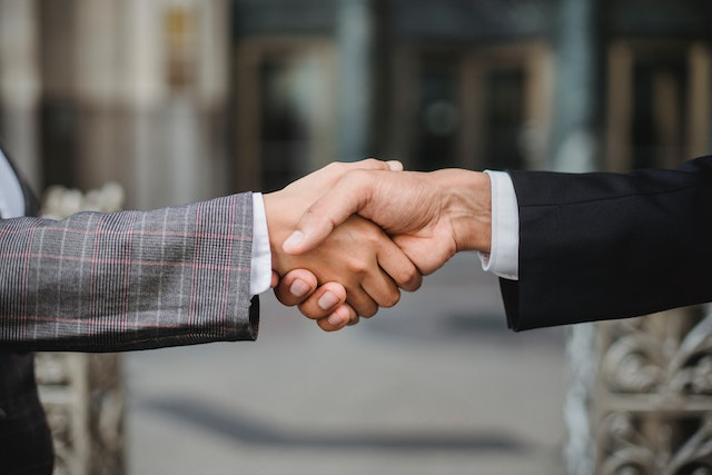 A public adjuster shaking hands with a client
