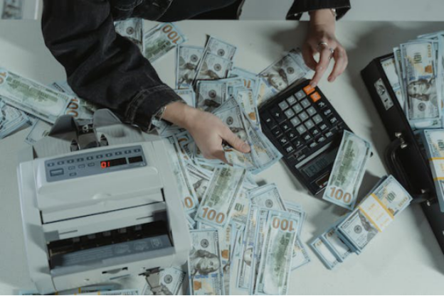 An individual counting dollar bills 