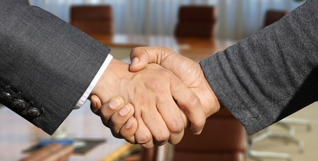 A public adjuster shaking hands after a successful negotiation