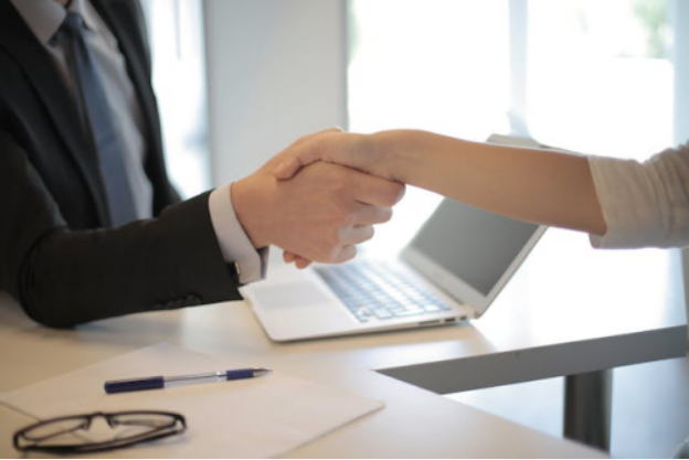 An individual shaking hands with a claims adjuster