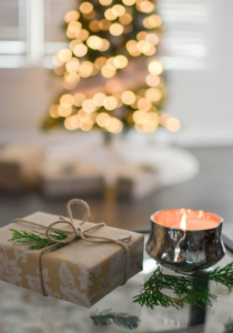 a votive candle and a wrapped present.