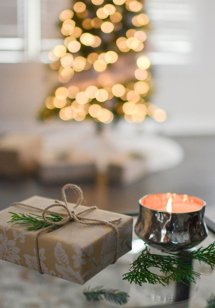 a votive candle and a wrapped present.