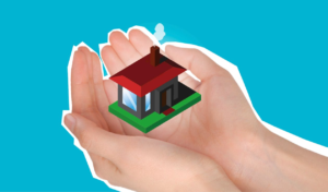 A pair of hands holding a miniature house